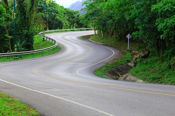 Fototapeta na wymiar Curve way of asphalt road in the green view.