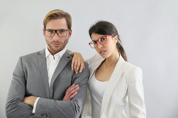 Business couple standing on grey background, isolated