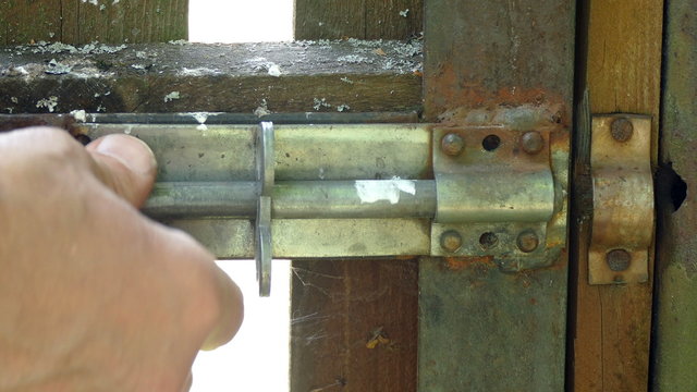 Door old latch on the gate in the garden