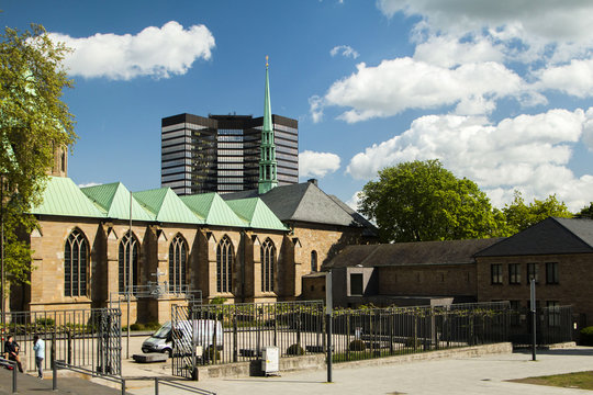 Cathedral in Essen and modern business tower, city skyline