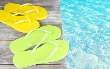 Colorful flip-flops on wooden boardwalk