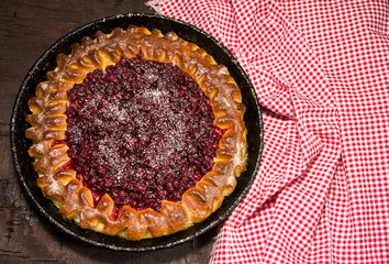 Open pie with cowberries