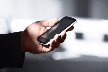 Male hand touching screen phone close-up