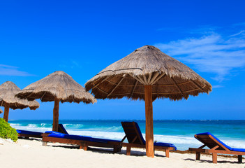 Beach chairs on exotic tropical sand beach