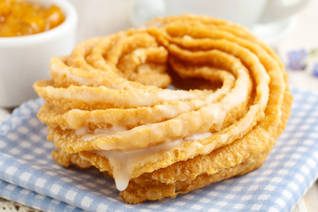 Churro donuts and bowl of honey