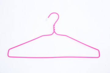 Pink wire hangers on white background