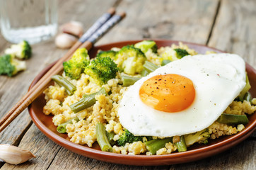 stir fried millet with broccoli, green beans and fried egg