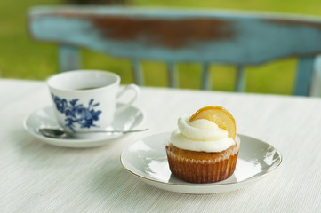 Lemon cupcake with cup of coffee