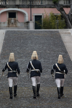 Three Portuguese National Guards walk towards the Belem Palace in Lisbon, Portugal.