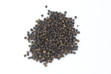 Black Peppercorns scattered and isolated on a white background