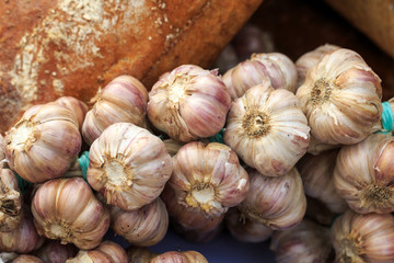 Close up of  rustic bread and bulbs of fresh garlic