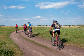 Group of tourists  mountain bike ride on dirt road. 