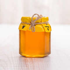 Jar of honey on wooden table