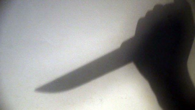 Shadow of a Knife Stabbing Down