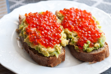 Sandwich with avocado and caviar
