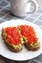 Sandwich with avocado and caviar