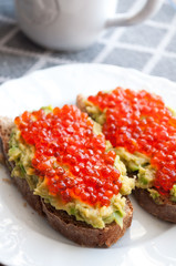 Sandwich with avocado and caviar