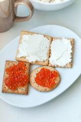 Crackers with cheese and red caviar
