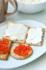 Crackers with cheese and red caviar