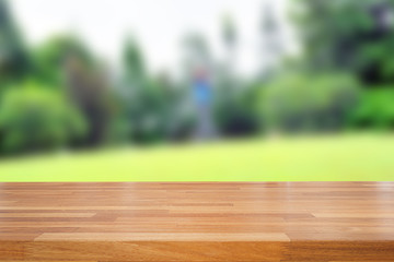 Empty wooden table and green nature background