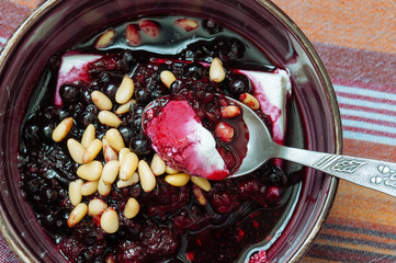 Cottage cheese with berry sauce and pine nuts