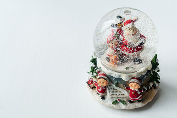Fototapeta na wymiar Snow globe with Santa Claus inside