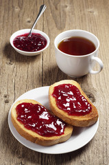 Fried bread with jam and tea cup