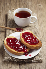 Toasted bread with strawberry jam and tea cup