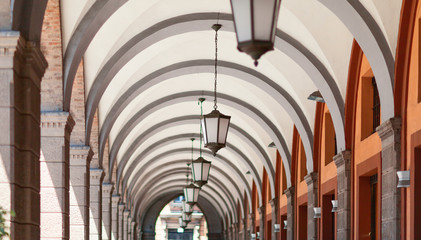 Corridor with hanging lamps from the floor. - obrazy, fototapety, plakaty