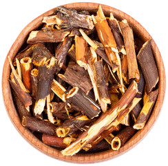 Dry Comarum in a small wooden bow isolated on white.