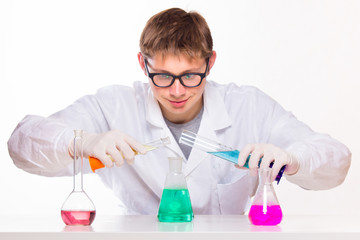 Young scientist doing chemical reactions in the laboratory