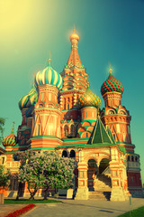 Fototapeta na wymiar Domes of St. Basil's Cathedral in Moscow's Red Square in Russia in sunny summer weather. Vintage style