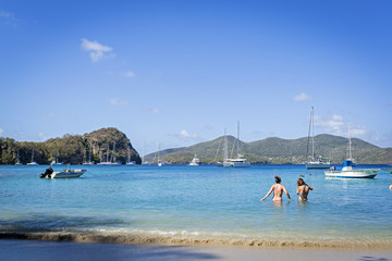 two girl going to bath in the transparent and tropical water