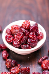 dried cranberries in a wooden spoon. fruit full of vitamin c.