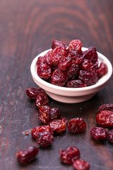 dried cranberries in a wooden spoon. fruit full of vitamin c.