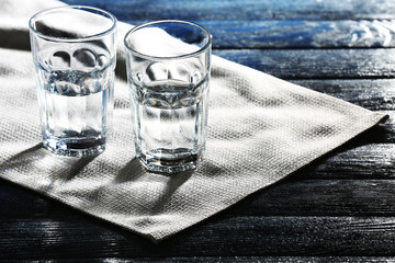 Two glasses of water on table on napkin close up