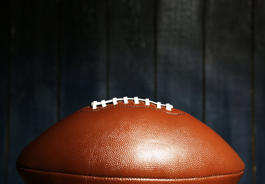 American football on wooden background