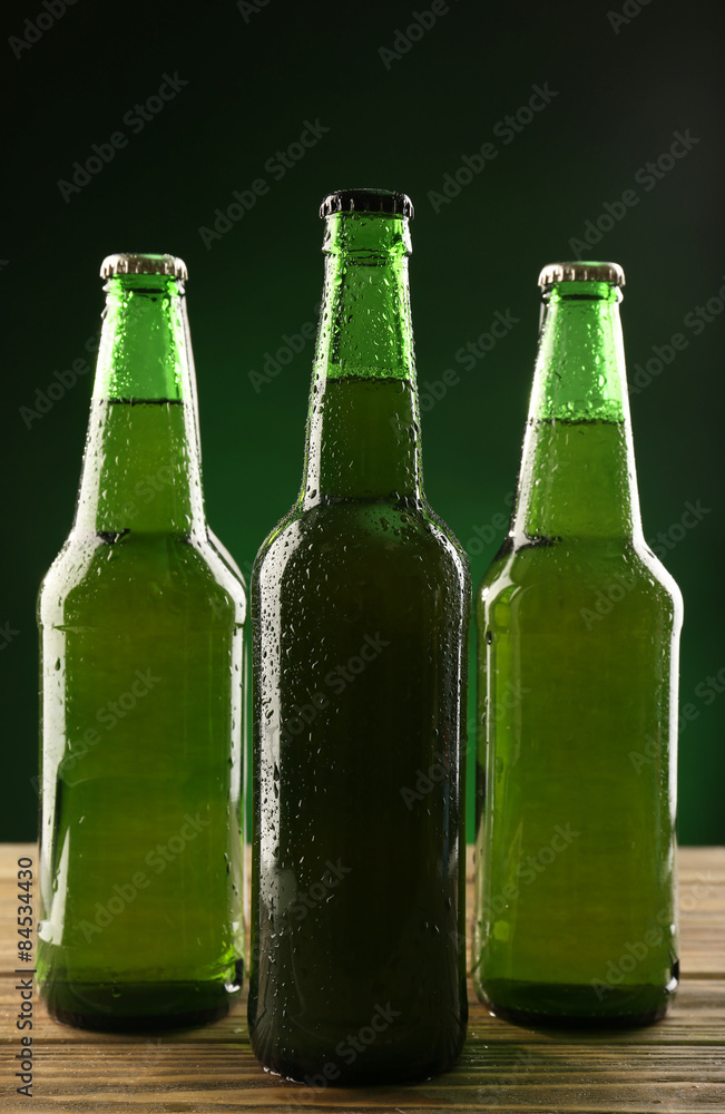 Sticker Glass bottles of beer on dark green background