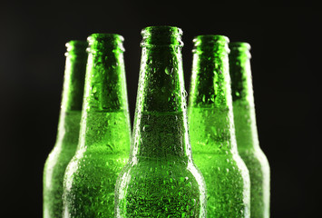Glass bottles of beer on dark background