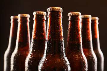 Glass bottles of beer on dark background