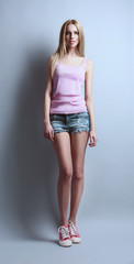 Expressive young model in casual style on gray background