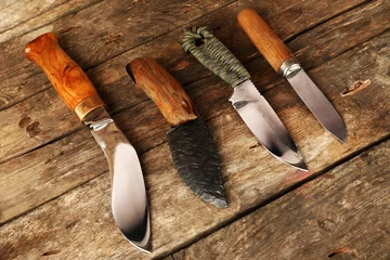 Fotobehang Hunting knives on wooden background © Africa Studio