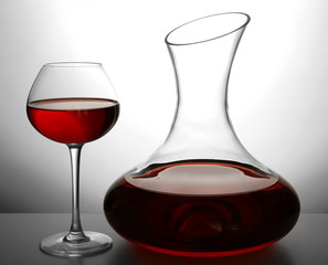 Glass carafe of wine on light background