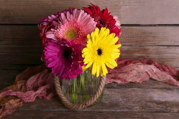 Fototapeta premium Still life with beautiful bright gerbera flowers on wooden background
