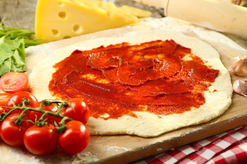 Food ingredients for pizza on table close up