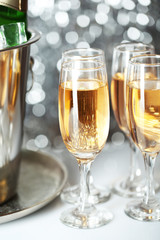 Glasses of champagne on bright background