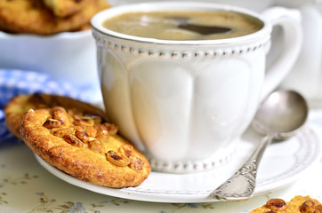 Homemade cookies with peanut and cup of coffee.