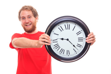 Happy man holding big clock on white