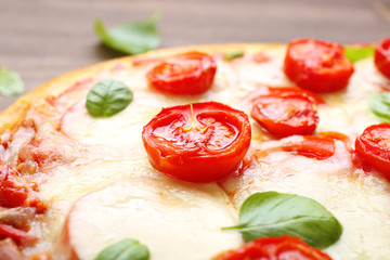 Delicious pizza with cheese and cherry tomatoes, closeup