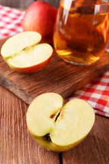 Naklejka na ściany i meble Glasses of apple juice on wooden table, closeup